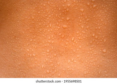 Water Drops On The Woman Skin. Human Skin And Sweat. Close Up Of Wet Human Skin.