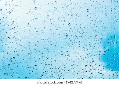 Water Drops Of Rain On Blue Glass Background