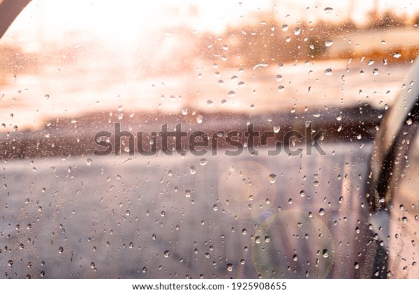 Water\
drops, rain sticking to car window glass with\
flare