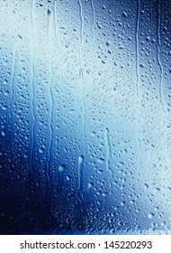 Water Drops Running Down Blue Glass