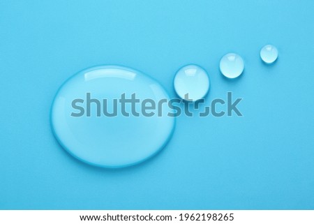 Water drops in shape of Thought bubble on blue background.
