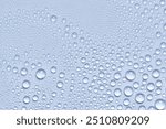 Water drops texture background. Spray, liquid droplets on blue surface