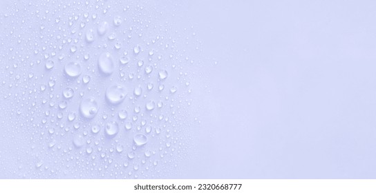 water drops of transparent gel serum on a pastel purple background