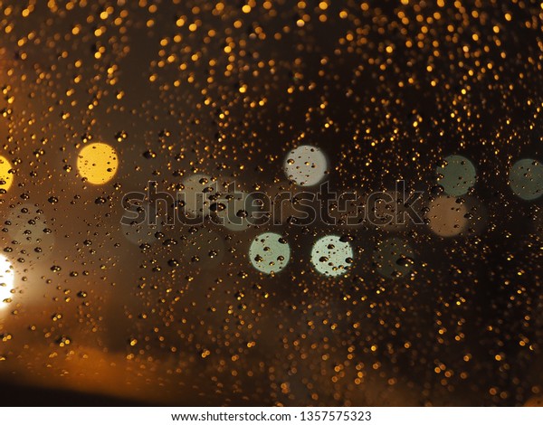 water\
drops in the windows with back ground in light\
blur