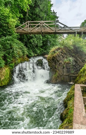 Water explodes through the lower section of Tumwater Falls in Tumwater, Washington.