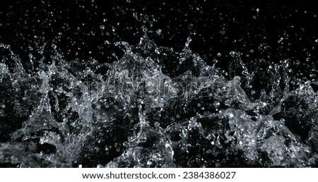 Water Exploding and Splashing against Black Background