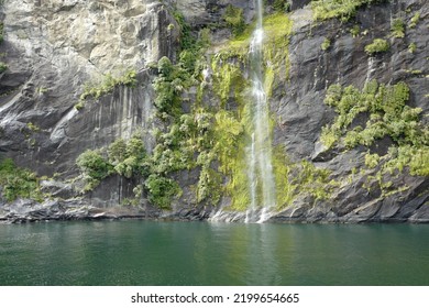 Water Falling Down A Steep Rock Cliff