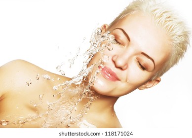 Water falling on the beautiful sensuality woman face with clean skin
