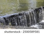 Water falling over small dam