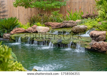 Water falls in the home garden.