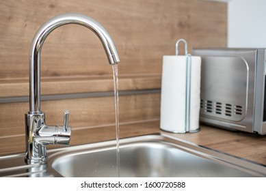 Water faucet in the kitchen. Running water from a tap. 