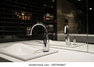 Water Faucet And Sink In A Public Bathroom, Closeup Shot