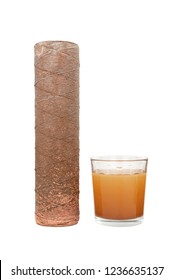 Water filter cartridge used and a glass of rusty water brown coloring. Evidence of contamination of tap water with iron cations.Isolated on white background.
