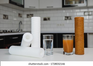 Water filter cartridge used and a glass of dirty water and new pure filter with a glass of clean water from domestic osmosis systems at kithen background. Concept of a water treatment.