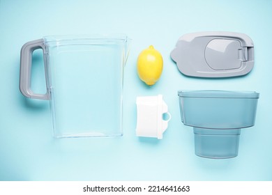 Water Filter Jug With Lemon On A Blue Background. Top View.