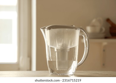 Water filter jug on table in kitchen