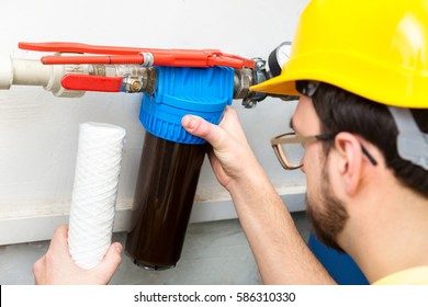 water filtering - plumber changing dirty water filter
