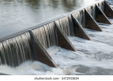 The water flow pass the weir from upper level to lower level - Powered by Shutterstock