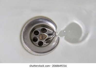 Water Flowing Away Into A White Stone Sink