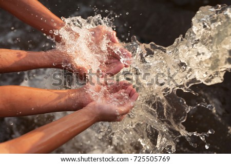 Water flowing in to children hand, Water conservation, ecology and environment concept.