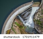 Water flowing over a dam as spring snowmelt fills East Canyon Reservoir in Utah