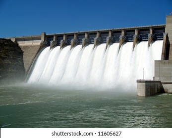 Water Flowing Over Flood Gates Of A Dam