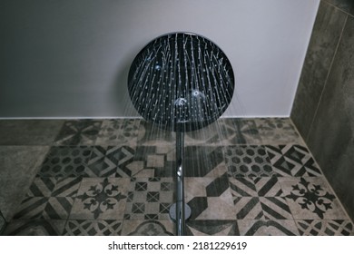 The Water Flowing From The Shower. Seen From Below The Shower Water. Close Up Of The Shower Head