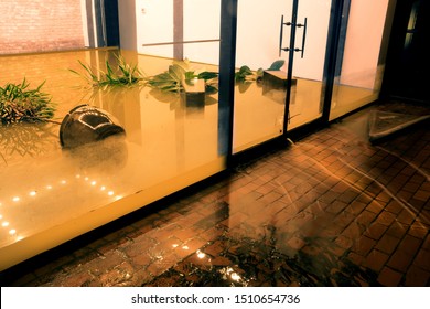  Water flowing through doors from a flooded office. Effects Tropical depression Imelda. Houston, Texas, US