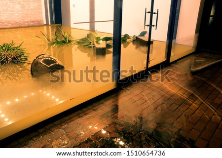  Water flowing through doors from a flooded office. Effects Tropical depression Imelda. Houston, Texas, US