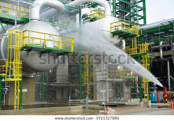 Water flowing vigorously from open fire hydrant\
as part of the fire extinguishing system testing for safety in the\
event of an emergency in chemical plants, power plants, oil and gas\
industry.