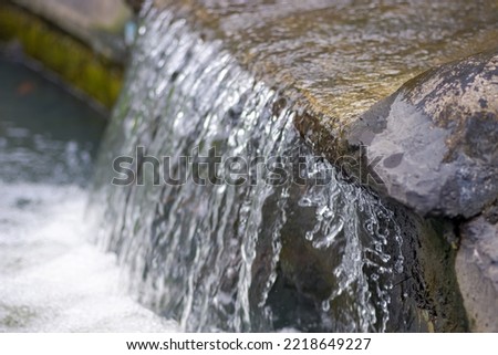 Water flows from the rocks in the residential garden 