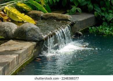 Water flows from the rocks in the residential garden