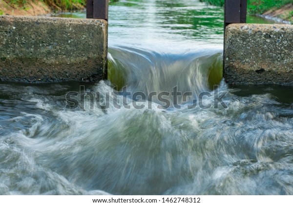 Water flows through the floodgate in the irrigation\
canal quickly.Water management, irrigation system, irrigation dam,\
irrigation canal To send to agricultural plots. To solve drought in\
northeast 