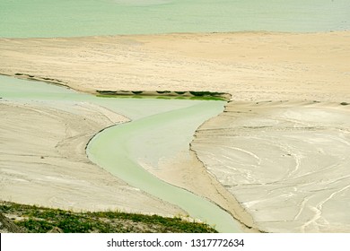 Water Flows Through Sediment On The Edge Of A Tailings Pond At A Copper Mine Near Ashcroft, British Columbia, Canada