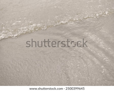 The water forms waves in the wind.