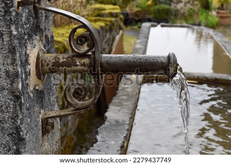 a water fountain in a city park pond images
