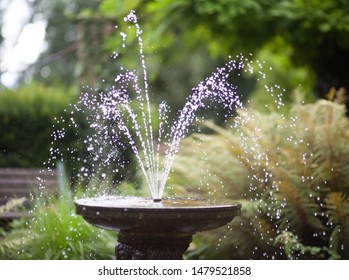 Water fountain with droplets in fountain. - Powered by Shutterstock