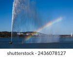 Water fountain on Lake Burley Griffin producing a rainbow, Canberra, Australia.