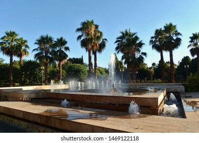 Water Fountain And Palm Trees In Granada City Park (Federico García Lorca Park), Andalusia, Spain