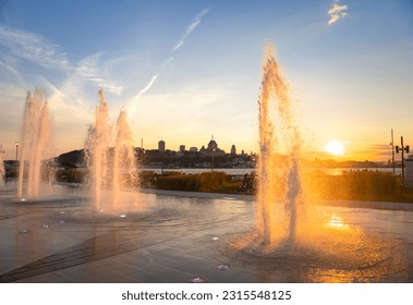 Water fountains backlit by an orange sunset - Shutterstock ID 2315548125