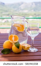 Water with fresh oranges on the terrace