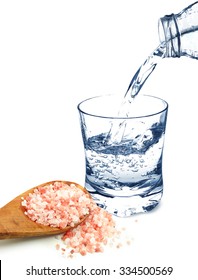 Water In A Glass And Himalayan Salt Isolated On White Background