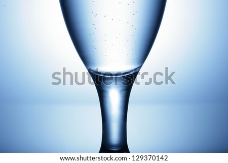water glass on reflecting ground shimmering blue