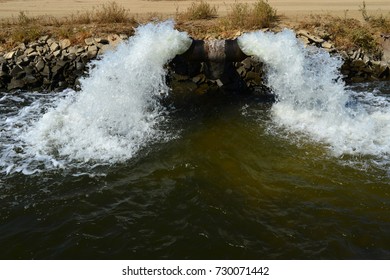 Water gushes from a pipe into a farm irrigation canal in Central California. The drought in prior years caused ground water to be pumped, lowering the water table.