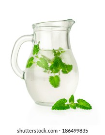 Water With Ice And Mint In A Glass Jug Isolated On White