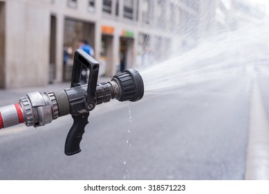Water jet splashing from a fire fighting firehose nozzle
