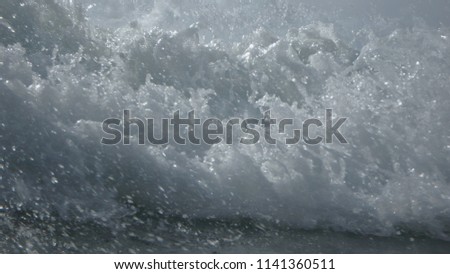 In the water at Karon Beach, Phuket Thailand. Perspective is from where the waves break as the swells turn to whitecaps and a wall of water comes at the camera.