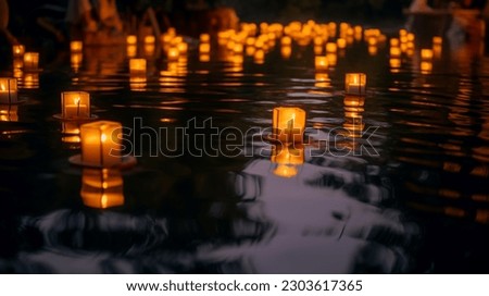 Water lanterns create a magical scene on a lake at night, evoking peace and spirituality. Shallow depth of field. 