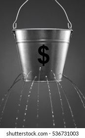 Water Leaking From Bucket With The Concept Of Finance And Losing Money