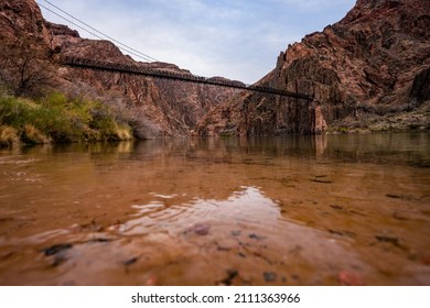 Water Level View Of The Colorado River And The Black Bridge In The Grand Canyon